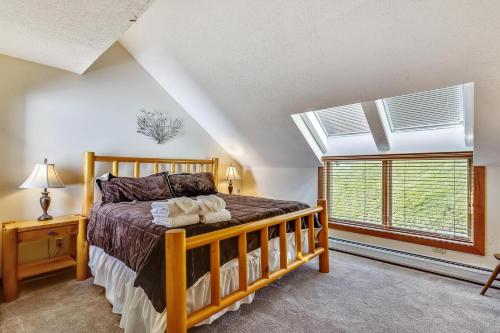 a bedroom with a wooden bed and a window at Sunrise Timberline I7 in Killington