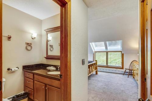 a bathroom with a sink and a mirror at Sunrise Timberline I7 in Killington