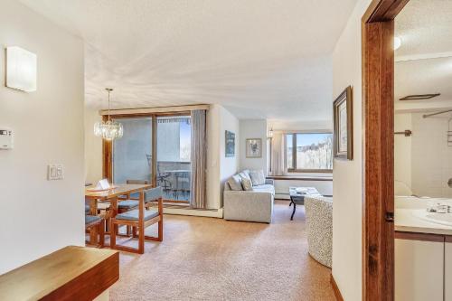 a living room with a table and a dining room at Sunrise Cambridge 101 in South Sherburne