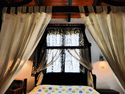 a bedroom with a bed and a window with curtains at Blue Bay Beach Hotel in Koinyra