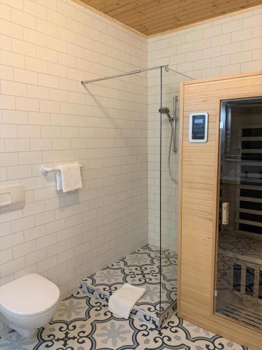 a bathroom with a toilet and a glass shower at Haus Agnes, Murau in Murau