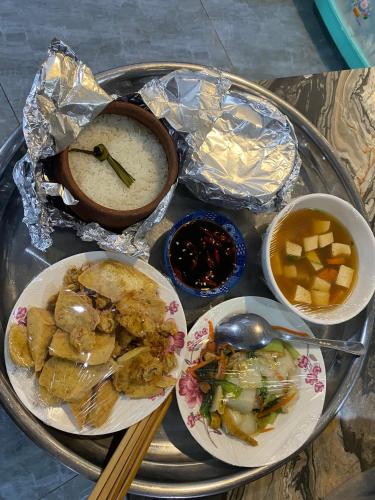 a tray of food with chopsticks and bowls of food at Cherry Hotel Bến Lức in Bến Lức