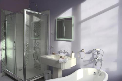 a bathroom with a shower and a sink and a tub at la maison in Libourne