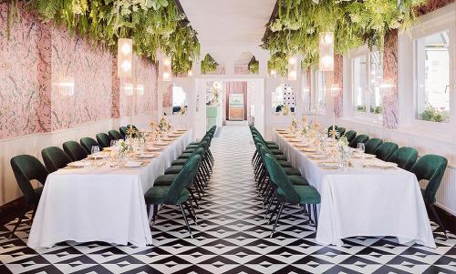 a dining room with white tables and green chairs at Fernblick in Sankt Corona am Wechsel