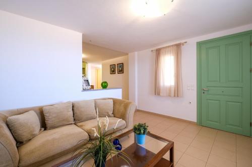 a living room with a couch and a table at Stella Di Mare family house in Agios Ioannis Tinos
