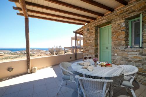a table on the balcony of a house at Stella Di Mare family house in Agios Ioannis