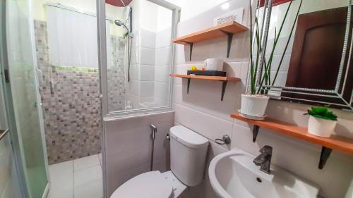 a bathroom with a toilet and a shower and a sink at Ananda Resort in Panglao