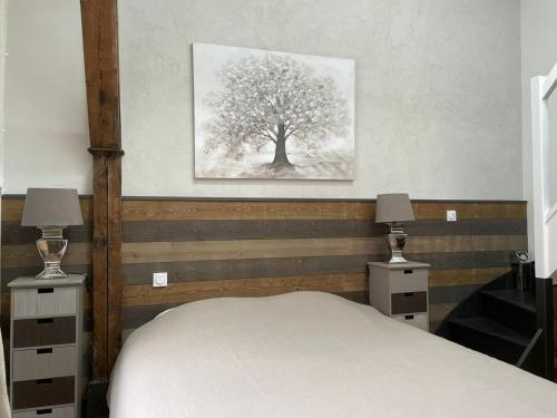 a bedroom with a bed and a picture of a tree at Maison d'hotes L'atelier du Charmois in Vandoeuvre-lès-Nancy