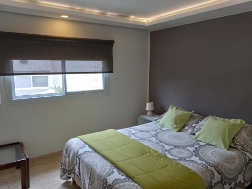 
a bedroom with a bed and a window at 770 Apart in Villa Carlos Paz
