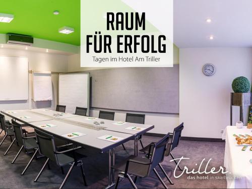 a conference room with a long table and chairs at Hotel Am Triller - Hotel & Serviced Apartments in Saarbrücken