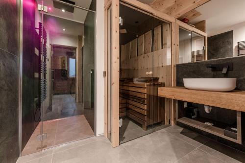 a bathroom with a sink and a shower at Nidaris - Luxury Private Spa Suites in Malè