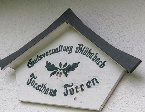 a sign on the side of a building at Forest Chalet, 15 min to salzburg olt town, and most beautiful lakes, secluded location, 1,000 sqm garden, mountainview, panorama sauna, bath whirlpool, BBQ&bikes&sunbeds for free, up to 10 p in Golling an der Salzach