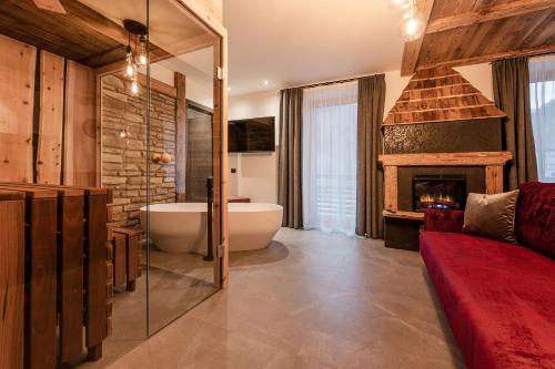 a bathroom with a bath tub and a fireplace at Nidaris - Luxury Private Spa Suites in Malè