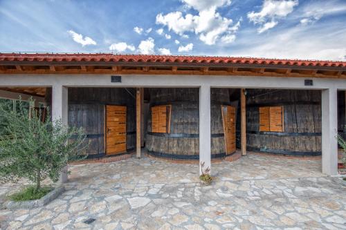 a house with wooden doors and a tile roof at Agroturizam Duvančić - Konoba dida Marka in Drniš