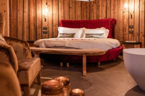 a bedroom with a bed with a red headboard at Nidaris - Luxury Private Spa Suites in Malè