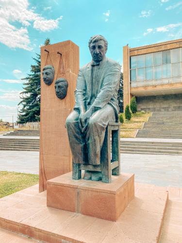 a statue of a man sitting on a bench at Modern apartment in the heart of Gyumri in Gyumri
