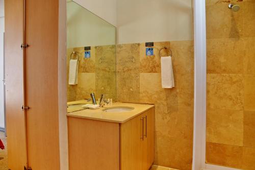 a bathroom with a sink and a shower at Fountains Hotel in Cape Town