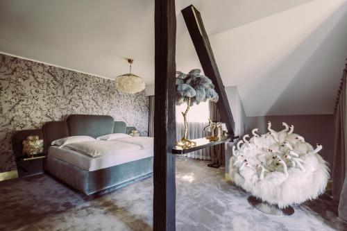 a bedroom with a bed and a chair in it at Fernblick in Sankt Corona am Wechsel