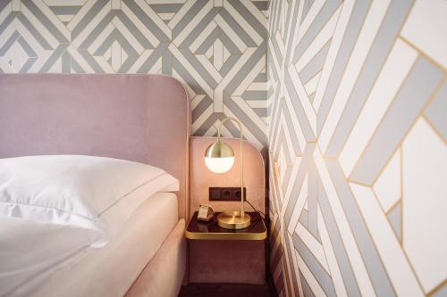a bedroom with a bed and a side table with a lamp at Fernblick in Sankt Corona am Wechsel