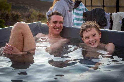 a man and a child in a bath tub at Starry Starry Night - Route 62 in Montagu
