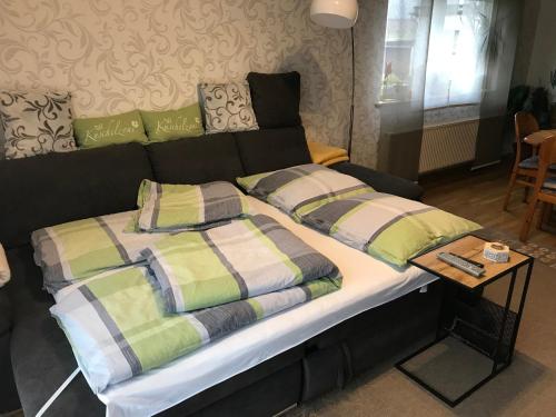 a bed with two pillows on it in a room at Gemütliche Wohnung im Westerwald, mit einer großen Terrasse!! in Weitefeld