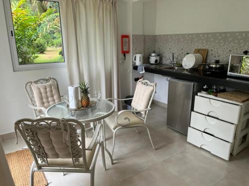 a kitchen with a table and chairs and a counter at SOUTH HILL VILLA in Mahe