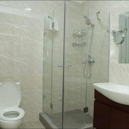 a bathroom with a shower and a toilet and a sink at ROYAL AFROSIYOB in Niyazmudin