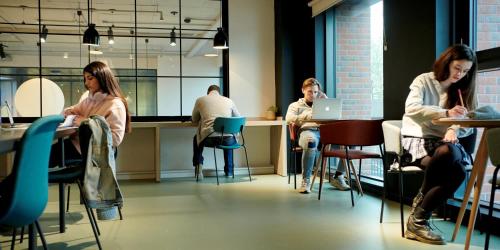 a group of people sitting at tables in a room at Private Bedrooms with Shared Kitchen, Studios and Apartments at Canvas Arundel House in the heart of Coventry in Coventry