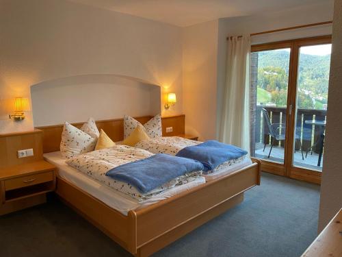 a bedroom with a large bed and a balcony at Haus Belvedere in Berchtesgaden