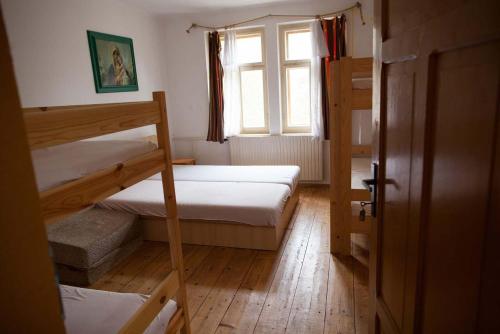 a room with two bunk beds and a window at Turistická ubytovna U Tlusťocha in Malá Skála