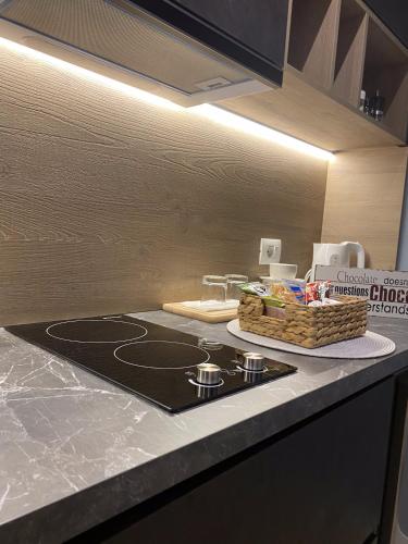 a kitchen with a stove and a counter top at Living Studio Apartments in Tirana