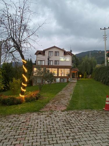 a house with a light pole in the yard at SNOW HİLL HOUSE Pansiyon in Kartepe