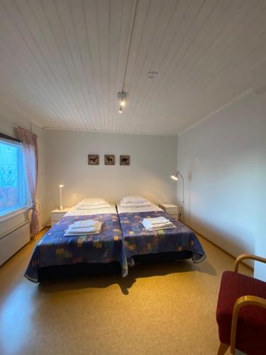 a bedroom with a large bed in a room at Economy Apartments Peura in Rovaniemi