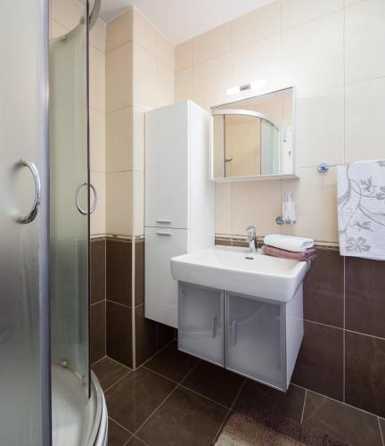a white bathroom with a sink and a shower at Villa Neresi - Charme Holidays in Nerežišće