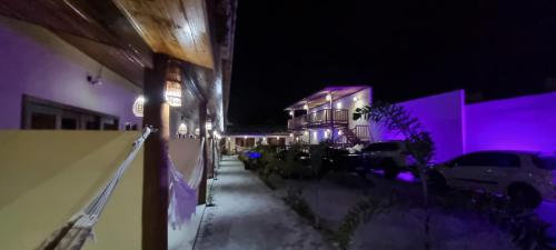a night view of a building with purple lights at Pousada Lua Nova Charmosa Pipa in Pipa