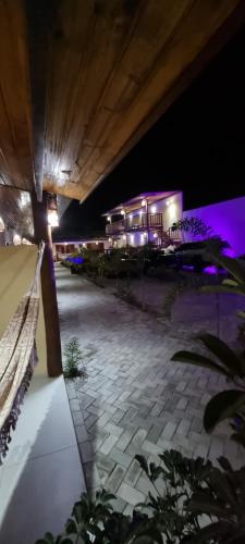 a night view of a building with purple lights at Pousada Lua Nova Charmosa Pipa in Pipa