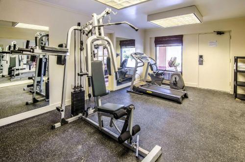 a gym with treadmills and machines in a room at Quality Inn Tanglewood in Roanoke