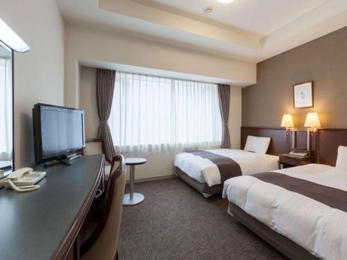 Ένα ή περισσότερα κρεβάτια σε δωμάτιο στο Comfort Hotel Toyokawa