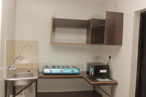 a kitchen with a blue stove and a sink at Sweet Lake Resort in Naivasha