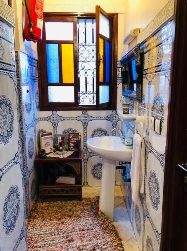 a blue and white bathroom with a sink and a window at Hostel Dream belko in Marrakesh