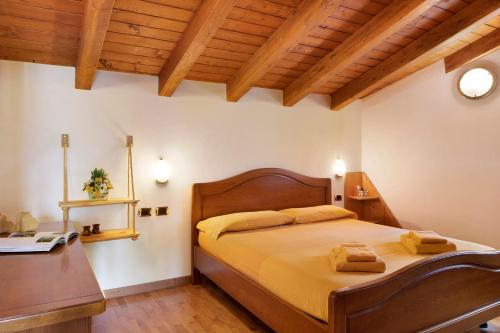 a bedroom with a large bed and a desk at Chalet Maffins 2 in Livigno