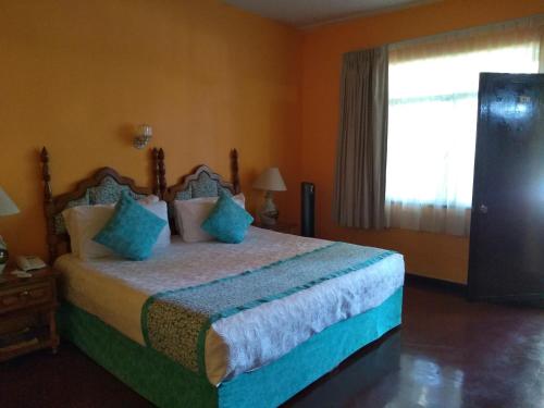 Hotel Posada Quinta Las Floresにあるベッド
