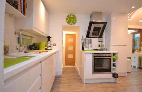 a kitchen with white counters and a stove top oven at Compact, central apartment, dog friendly. in Kingsbridge