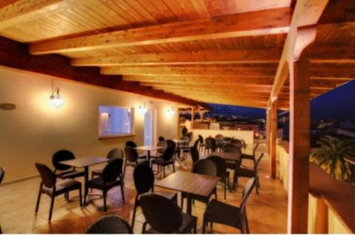 a restaurant with tables and chairs in a room at B&B San Matteo in Scalea