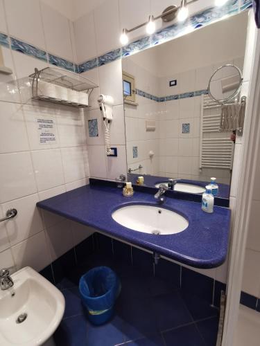 a bathroom with a sink and a toilet at Al Baglio in Mondello