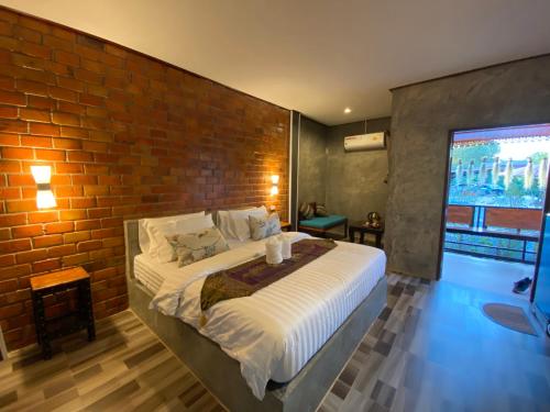 Postel nebo postele na pokoji v ubytování Khum Lanna Boutique Hotel