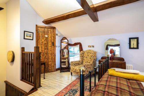 a bedroom with a bed and a chair at Sorley Boys Snug in Derry Londonderry