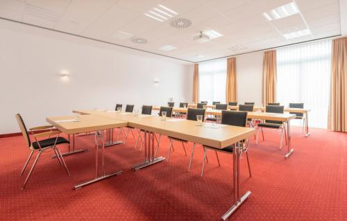 a conference room with a long table and chairs at Best Western Plus Hotel Papenburg in Papenburg