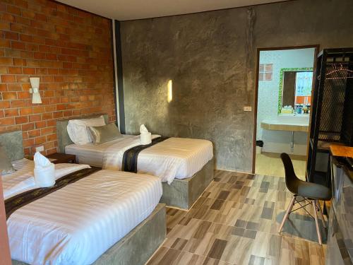 Postel nebo postele na pokoji v ubytování Khum Lanna Boutique Hotel
