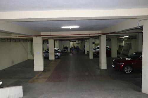 an empty parking garage with cars parked in it at Hotel SK Riverfront in Vijayawāda